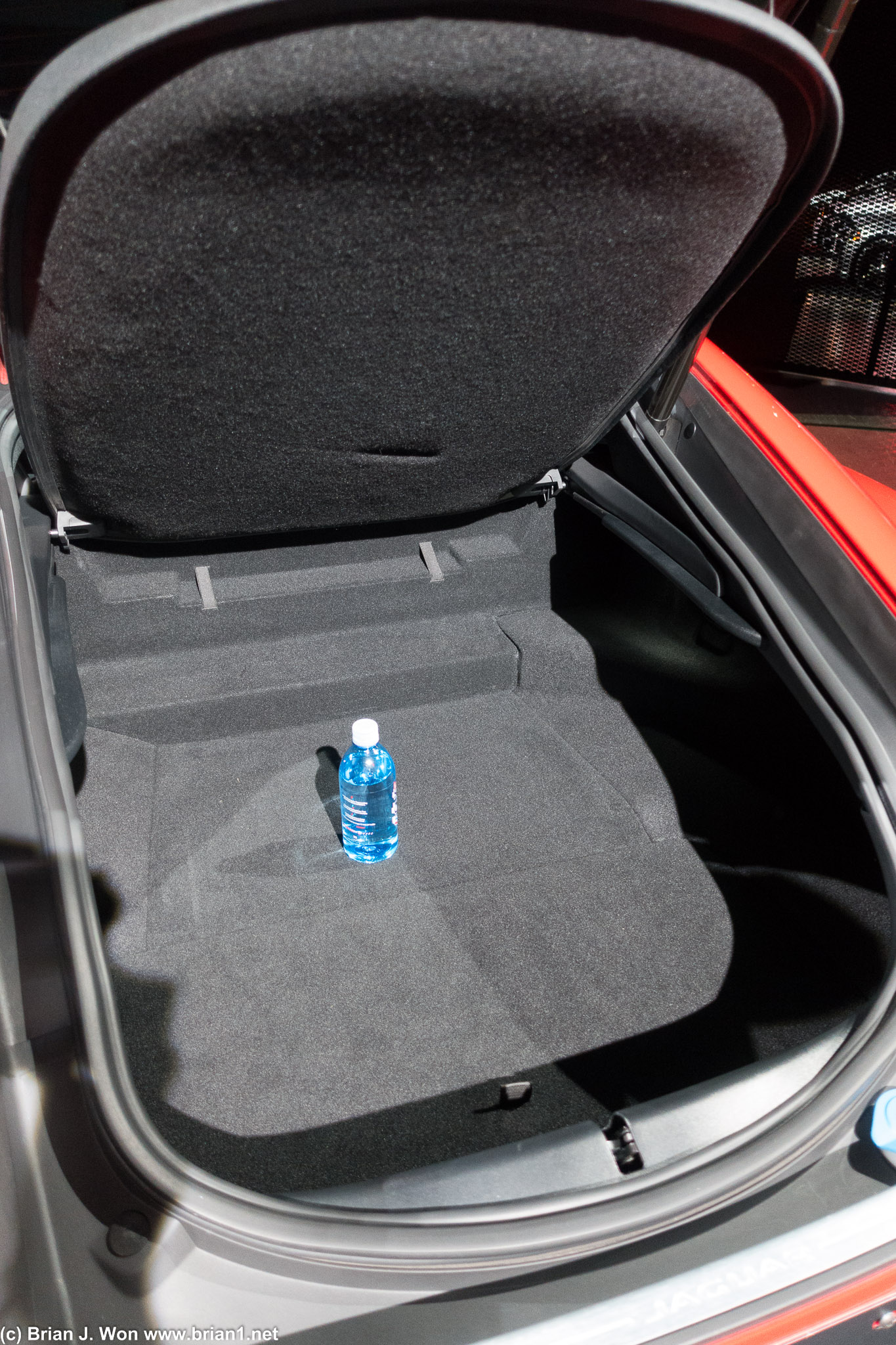 Rear cargo area is okay. Pretty shallow. Water bottle for scale.