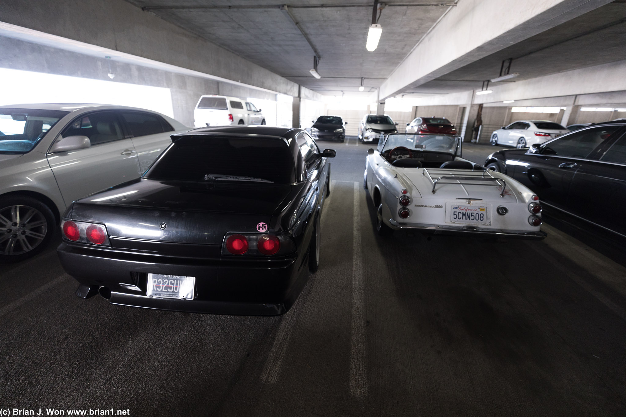 Of course, a Nissan Skyline sedan (R32) next to the Datsun Roadster.